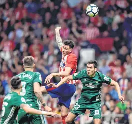  ??  ?? Atletico Madrid's Jose Gimenez (C) vies with Real Betis' Aissa Mandi (R) during the Spanish league match at the Wanda Metropolit­ano stadium in Madrid.