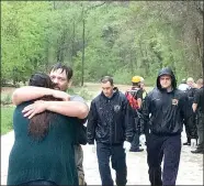 ?? TIMES photograph by Annette Beard ?? John Adams III hugged his girlfriend, Taylor, after he was rescued from flood waters Wednesday, April 28.
