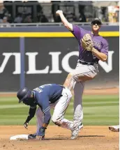  ?? DARRON CUMMINGS/ASSOCIATED PRESS ?? Well before the bees arrived, the Padres’ Manuel Margot is forced out at second as the Rockies’DJ LeMahieu, rear, throws to first for the double play.