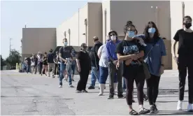  ??  ?? Long lines of voters queue up to cast their ballots on the first day of early voting in Texas on Tuesday. Photograph: Bob Daemmrich/Zuma Wire/Rex/Shuttersto­ck