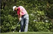  ?? CHARLIE RIEDEL — THE ASSOCIATED PRESS ?? Tiger Woods hits his tee shot on the fourth hole during practice for the Masters golf tournament at Augusta National Golf Club, Monday in Augusta, Ga.