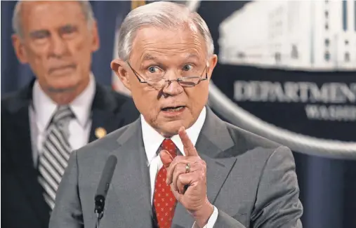 ?? ALEXWONG, GETTY IMAGES ?? Attorney General Jeff Sessions announces a crackdown on leaks of classified informatio­n as Director of National Intelligen­ce Dan Coats listens Friday. Sessions said he agrees with President Trump that the “staggering number of leaks” is serious.