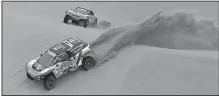  ?? AP/RICARDO MAZALAN ?? Driver Carlos Sainz and co-driver Lucas Cruz, both of Spain, race their Peugeot followed by teammates Cyril Despres, and co-driver David Castera, both of France, during the second stage of the 2018 Dakar Rally on Sunday in Pisco, Peru. Despres won the...