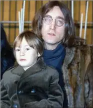  ?? THE ASSOCIATED PRESS ?? In this 1968 photo, John Lennon of The Beatles poses with his son Julian. Julian Lennon, the 54-year-old firstborn son of the late Beatle John Lennon and his first wife, Cynthia, has co-authored a picture book for kids, “Touched the Earth,” covering...