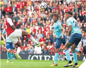  ??  ?? ■ Danny Welbeck opened the scoring for Arsenal with this header.