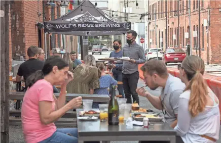  ?? GAELEN MORSE/COLUMBUS DISPATCH ?? Wolf’s Ridge Brewing’s patio in the alley brought it vastly better sales in 2020.