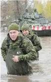 ?? RYAN REMIORZ, CP ?? Canadian Forces personnel wade through flooded streets of Deux-Montagnes, Que., on Monday.