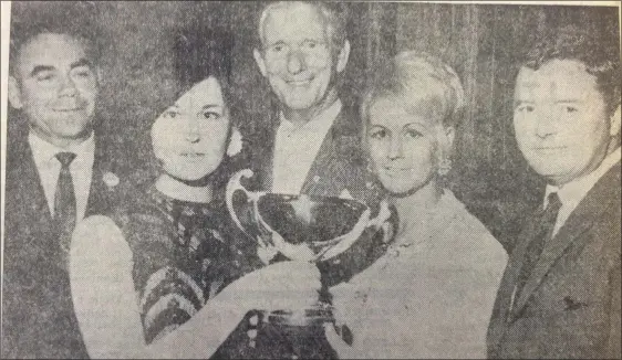  ??  ?? From 1967....Mrs F Morgan presenting the Morco Cup to Miss Hilda McGowan, who won the award for Girl with the Prettiest Dress at Drogheda Musical Society’s annual gala in the Abbey ballroom with Messrs B Brannigan, Kevin Hilton and Mr F Morgan.