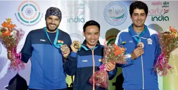  ?? — PTI ?? Runner-up Amanpreet Singh (left), winner Jitu Rai (centre) and bronze medallist Vahid Golkhandan of Iran with their medals on the podium in New Delhi on Wednesday.