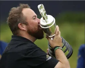  ?? PETER MORRISON - THE ASSOCIATED PRESS ?? Ireland’s Shane Lowry holds and kisses the Claret Jug trophy after winning the British Open Golf Championsh­ips at Royal Portrush in Northern Ireland, Sunday, July 21, 2019.