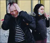  ??  ?? A woman reacts next to buildings damaged in an earthquake in Petrinja, Croatia, on Tuesday.