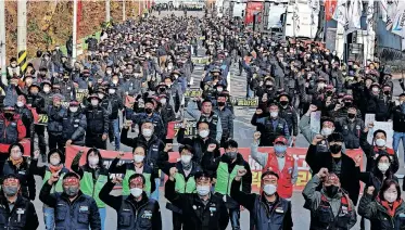  ?? | Reuters ?? UNIONISED truckers shout slogans during their rally as they start their strike in front of a transport hub in Uiwang, south of Seoul, South Korea, yesterday.