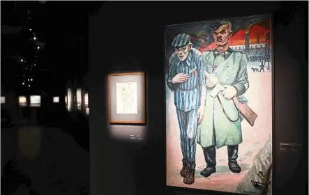  ?? — AFP ?? The Auschwitz museum unveils its largest-ever exhibition of drawings and paintings by Olere, a survivor of the WWII Nazi German death camp who went on to detail his experience­s in the crematoria and gas chambers on canvas after the war.