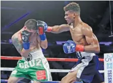  ?? THE ASSOCIATED PRESS ?? Ryan Martin punches Bryant Cruz during the fifth round of a lightweigh­t boxing match on March 18 in New York. Martin stopped Cruz in the eighth round and fights again tonight in Las Vegas.