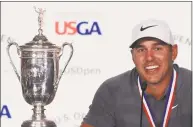 ?? Andrew Redington / Getty Images ?? Brooks Koepka speaks to the media after winning the U.S. Open at Shinnecock Hills Golf Club on Sunday.