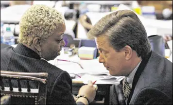  ?? BOB ANDRES / AJC ?? Rep. Sheila Jones (left), D-Atlanta, confers with Rep. Rich Golick, R-Smyrna, prior to the passage of HB 515, which trades precincts between Jones’ and Golick’s districts. Jones said she didn’t know about the bill until it was being presented.