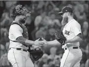  ?? ELISE AMENDOLA/AP PHOTO ?? Boston Red Sox closer Craig Kimbrel celebrates with catcher Sandy Leon after they defeated the Toronto Blue Jays 4-3 on Thursday night at Boston.