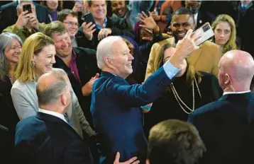  ?? PATRICK SEMANSKY/AP ?? President Joe Biden takes a photo at a union training facility Wednesday in DeForest, Wisconsin.