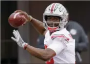  ?? NATI HARNIK — THE ASSOCIATED PRESS FILE ?? In this file photo, Ohio State quarterbac­k J.T. Barrett (16) warms up before an NCAA college football game against Nebraska in Lincoln, Neb. Barrett has shattered nearly every Ohio State passing and scoring record but isn’t a top NFL prospect. He...