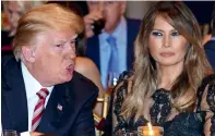  ?? AFP ?? President Trump and first lady Melania Trump sit down for Thanksgivi­ng dinner at his resort in Palm Beach, Florida. —