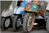  ?? Reuters ?? A restored Vespa painted in truck art style, is parked alongside other scooters at a workshop in Islamabad. —