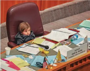  ?? PHOTOS BY GABRIELA CAMPOS/THE NEW MEXICAN ?? Sen. Cliff Pirtle’s son sits in the Roswell Republican’s chair as the Senate wraps the 2018 legislativ­e session Thursday.