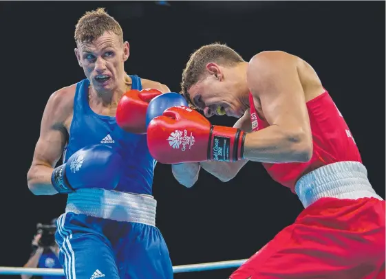  ?? Picture: GETTY IMAGES ?? Sean McComb (left) takes on Luke McCormack of England during the men's light welterweig­ht preliminar­ies at the Games.