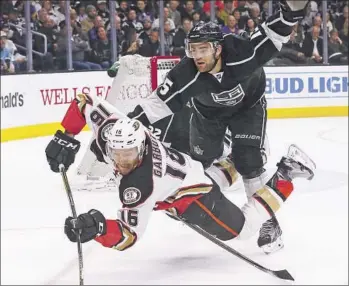  ?? Luis Sinco Los Angeles Times ?? THE DUCKS’ Ryan Garbutt goes down after getting tangled up with Kings forward Andy Andreoff.