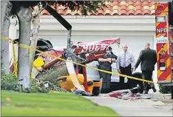  ?? Allen J. Schaben Los Angeles Times ?? POLICE investigat­e the site where a Robinson R44 helicopter crashed in Newport Beach in January, killing the pilot and two passengers.