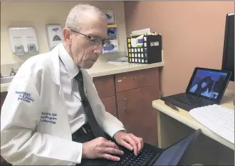  ?? COURTESY OF PENN STATE HEALTH ?? Dr. Zachary Simmons, the director of the Penn State ALS Clinic, documents his findings of patient Cynthia Lacey, seen here on Simmons’ laptop monitor during a recent appointmen­t. Lacey, who lives two hours away in Tobyhanna, Monroe County, uses Tele ALS to counter the times where she is unable to physically make it to Hershey for an appointmen­t.