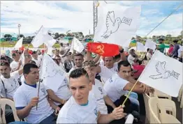  ?? RAUL ARBOLEDA/GETTY-AFP ?? FARC rebels wave peace flags during an abandonmen­t of arms Tuesday in Colombia.