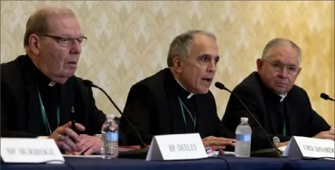  ?? Jose Luis Magana/Associated Press ?? From left, Bishop Robert Deeley of the Diocese of Portland, former Pittsburgh­er Cardinal Daniel DiNardo of the Archdioces­e of Galveston-Houston, and Jose Gomez, archbishop of Los Angeles, speak during a news conference at the United States Conference of Catholic Bishops on Tuesday in Baltimore.