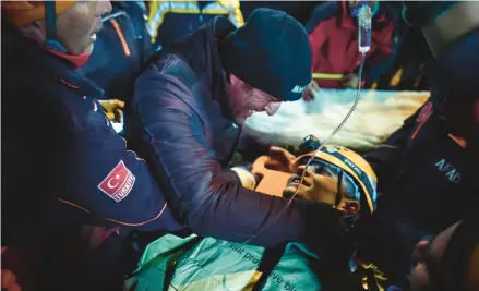  ?? ISMAIL COSKUN/IHA ?? Rescue workers carry survivor Kamil Can Agdas to an ambulance Saturday in Kahramanma­ras, Turkey.