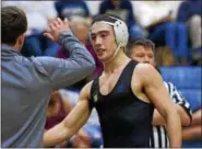  ?? AUSTIN HERTZOG - DIGITAL FIRST MEDIA ?? Pope John Paul II’s Ryan Vulakh is congratula­ted after winning the 145-pound final over Methacton’s Roman Moser via second-period technical fall at the District 1-AAA Central Tournament at Spring-Ford.