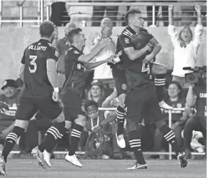  ?? JOSHUA A. BICKEL/COLUMBUS DISPATCH ?? Columbus Crew midfielder Lucas Zelarayan (10) celebrates with defender Jonathan Mensah (4) after a Cruz Azul own goal during the first half of the Campeones Cup between the Columbus Crew and Cruz Azul on Wednesday at Lower.com Field in Columbus.