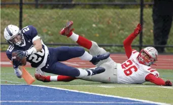  ?? BOSTON HERALD FILE ?? CLOSE, BUT NOT QUITE: St. John's Prep's Matt Duchemin (left) lunges for the pylon but not before Catholic Memorial's Will Stockwell drags him out-of-bounds.