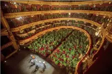  ?? Emilio Morenatti/Associated Press ?? Musicians rehearse onstage at the Gran Teatre del Liceu in Barcelona, Spain, on June 22, when the opera house reopened with its 2,292 seats occupied by potted plants.