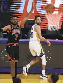  ??  ?? Curry and Chicago’s Troy Brown Jr. watch the Golden State guard’s 3point try find the net.