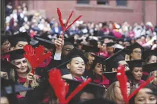  ?? STEVEN SENNE/AP ?? HARVARD UNIVERSITY STUDENTS CELEBRATE THEIR GRADUATE DEGREES in public health during Harvard commenceme­nt ceremonies on May 25 in Cambridge, Mass.