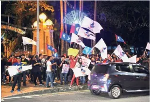  ??  ?? Showing their displeasur­e: Supporters of Warisan and PKR demonstrat­ing at the entrance to Istana Negeri in Sabah earlier.