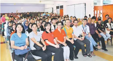  ??  ?? Toh (seated fifth left, front row) with the volunteers after a briefing session at Unimas yesterday.