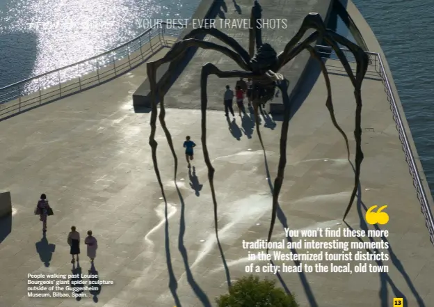  ?? ?? People walking past Louise Bourgeois’ giant spider sculpture outside of the Guggenheim Museum, Bilbao, Spain.