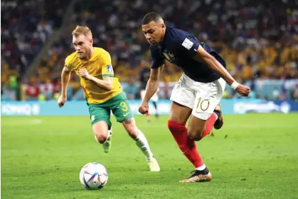  ?? Photograph: Patrick Smith/FIFA/Getty Images ?? Kylian Mbappé takes on Nathaniel Atkinson at Al Janoub Stadium.