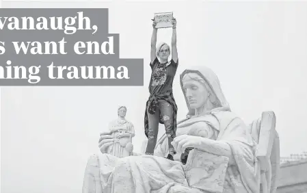  ?? ERIK S. LESSER/EPA-EFE ?? A woman protests on a statue outside the Supreme Court after the Senate voted Saturday to confirm Supreme Court nominee Brett Kavanaugh.