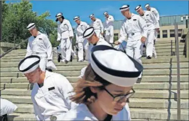  ??  ?? In this June 27 file photo, incoming plebes carry their belongings down a staircase during Induction Day at the U.S. Naval Academy, in Annapolis, Md. [PATRICK SEMANSKY/ASSOCIATED PRESS FILE PHOTO]