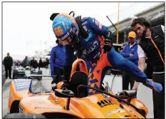  ?? AP/MICHAEL CONROY IndyCar driver Fernando Alonso climbs into his car during auto racing testing at the Indianapol­is Motor Speedway on Wednesday. ??