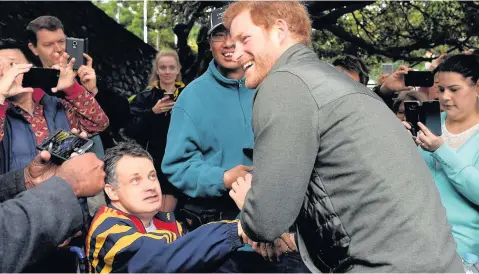  ??  ?? > Prince Harry meets members of the public as he arrives for a venue tour of the Sydney Internatio­nal Aquatic Centre yesterday in Sydney, Australia. Prince Harry is on a two-day visit to Sydney for the launch of the Invictus Games Sydney 2018. The...