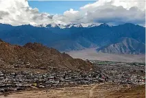  ??  ?? Buildings sit in the Leh Valley as the Himalayas stand in the background.