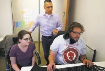  ?? Paul Chinn / The Chronicle ?? Mark Weidick (center), CEO of data analytics startup HiQ Labs, works with Liz Brokken and Cameron Cole in S.F.