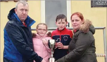  ??  ?? The Ryan famiy with the Ciara Ryan Memorial Cup, Anthony and Trish Ryan with their children Eabha and Jack.